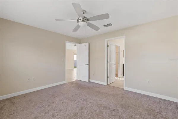 a bathroom with a toilet a sink a mirror and a shower