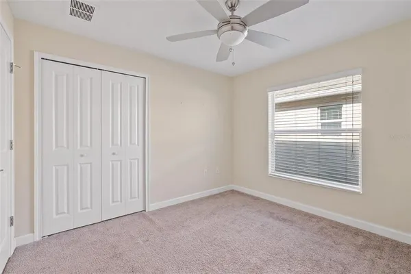 an empty room with a fan and a fan