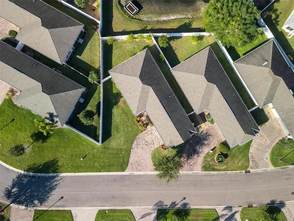 an aerial view of a house with a yard
