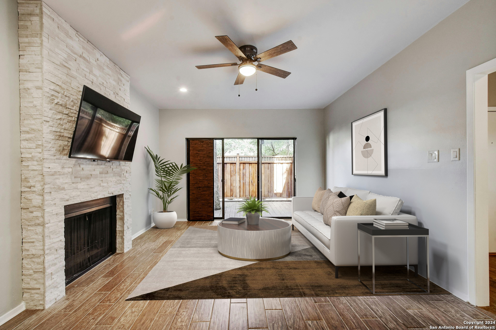 a living room with furniture fireplace and window