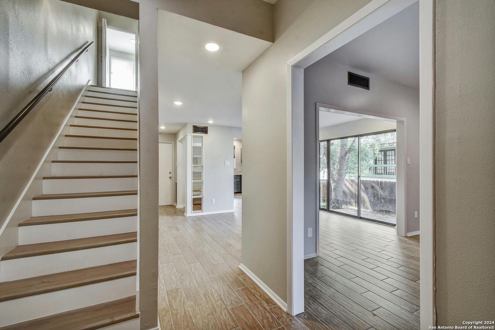 143 Terrell Road, Unit 1/2 San Antonio, TX 78209 - Photo 17 of 31 a view of a hallway with wooden floor and staircase