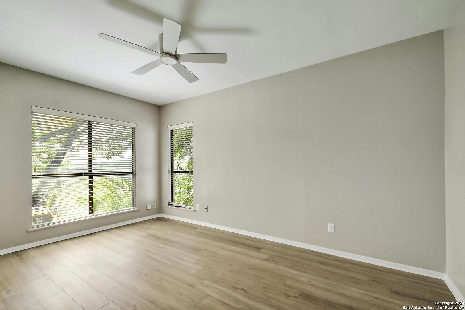 143 Terrell Road, Unit 1/2 San Antonio, TX 78209 - Photo 23 of 31 an empty room with wooden floor and windows