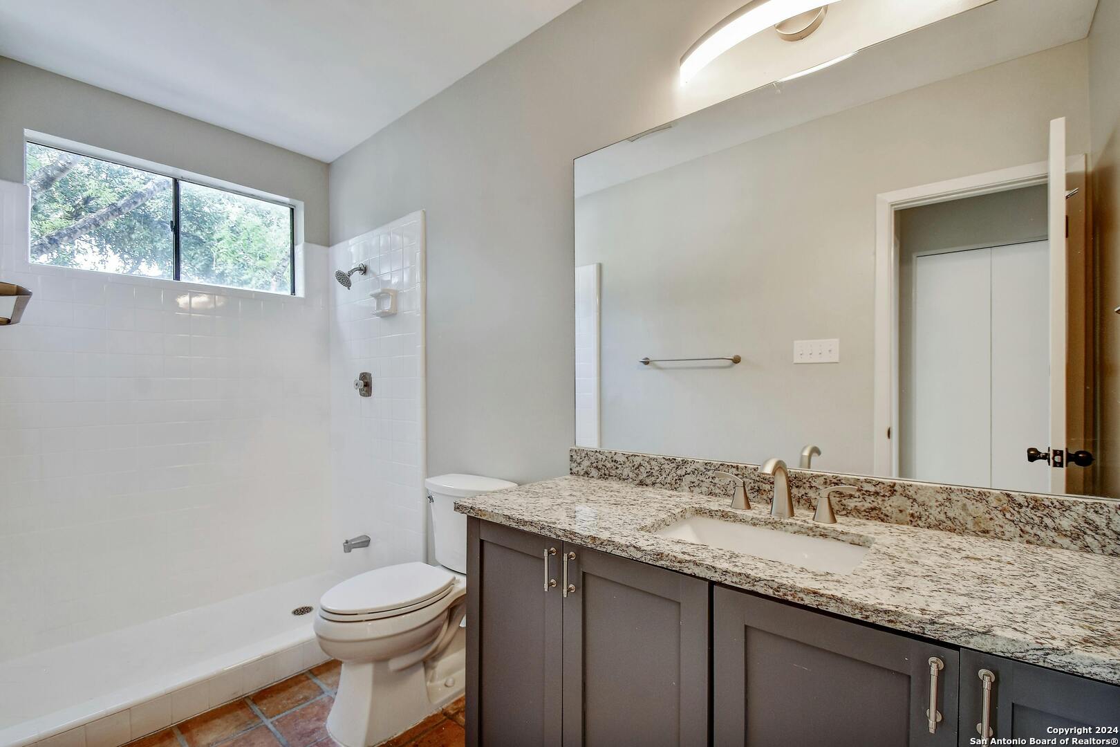 143 Terrell Road, Unit 1/2 San Antonio, TX 78209 - Photo 24 of 31 a bathroom with a granite countertop sink toilet and shower