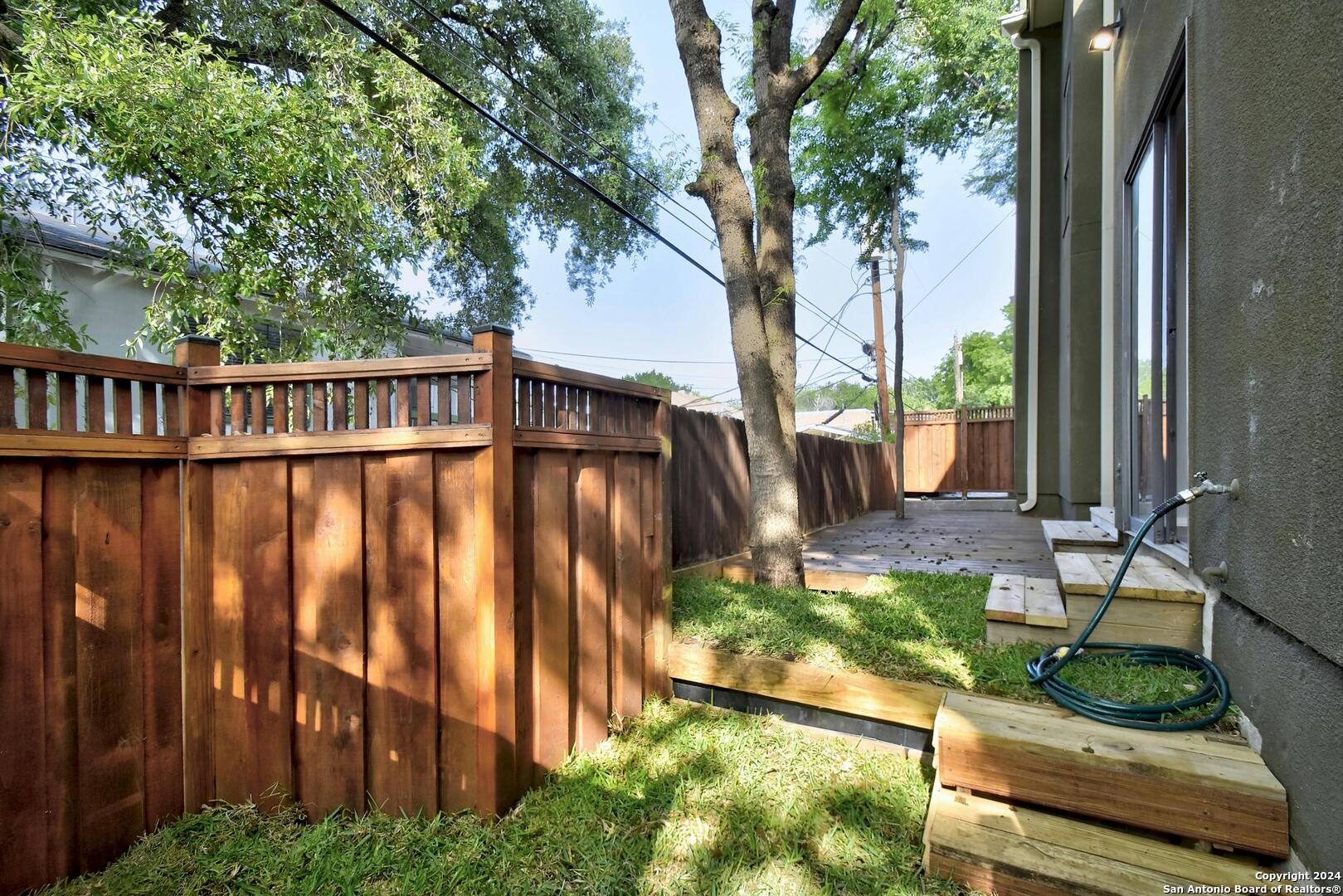 143 Terrell Road, Unit 1/2 San Antonio, TX 78209 - Photo 30 of 31 a view of a yard with large trees and plants