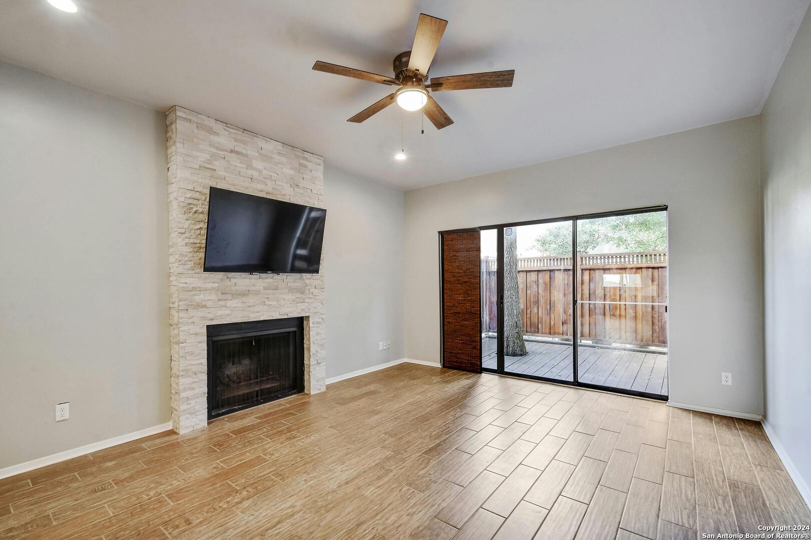 143 Terrell Road, Unit 1/2 San Antonio, TX 78209 - Photo 10 of 31 an empty room with windows fireplace and fan