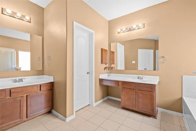 a spacious bathroom with a granite countertop sink a mirror and a