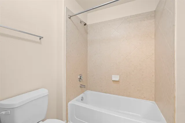 a white bath tub sitting next to a white toilet