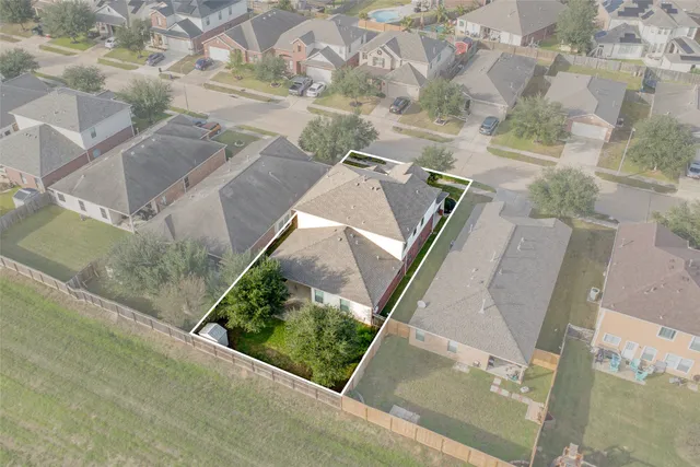 an aerial view of a house with a yard