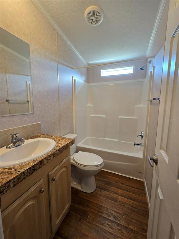 55716 Keith Street Astor, FL 32102 - Photo 11 of 12 a bathroom with a granite countertop sink toilet and shower