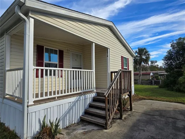 a view of backyard with deck and wooden floor