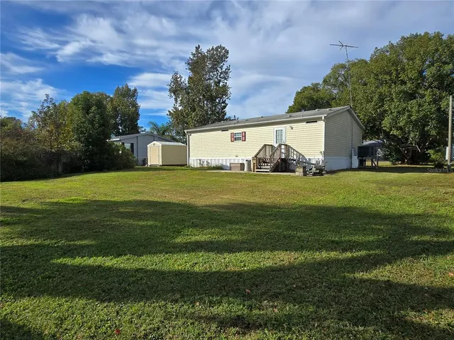 a view of a house with a yard and garage