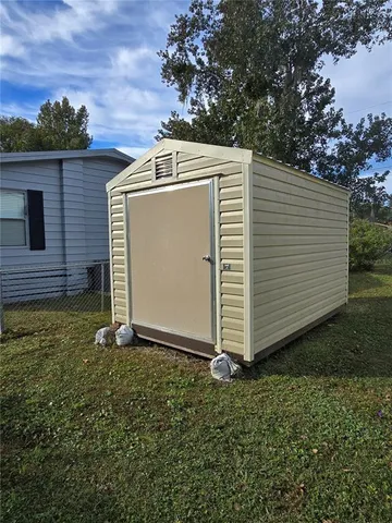 a view of backyard with pathway and a barn