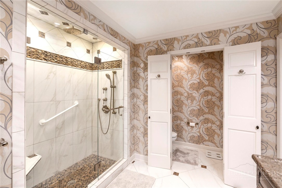 361 The Lakes, Unit C9 Boone, NC 28607 - Photo 25 of 47 a bathroom with a glass shower door and a bathtub