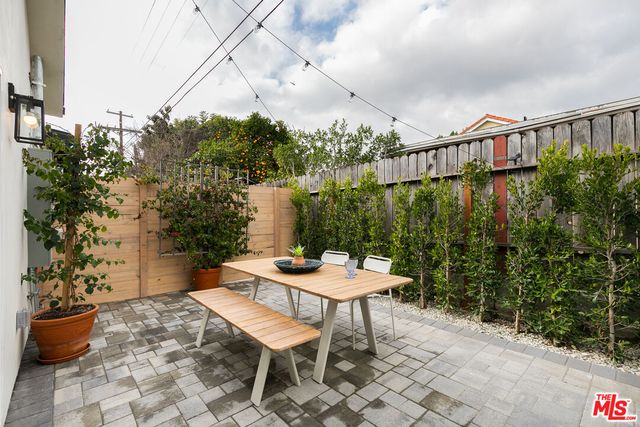 a backyard of a house with a table and chairs