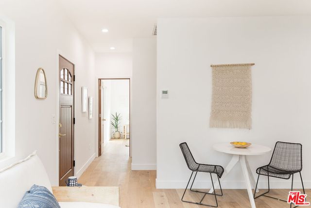 a bedroom with a bed and a potted plant
