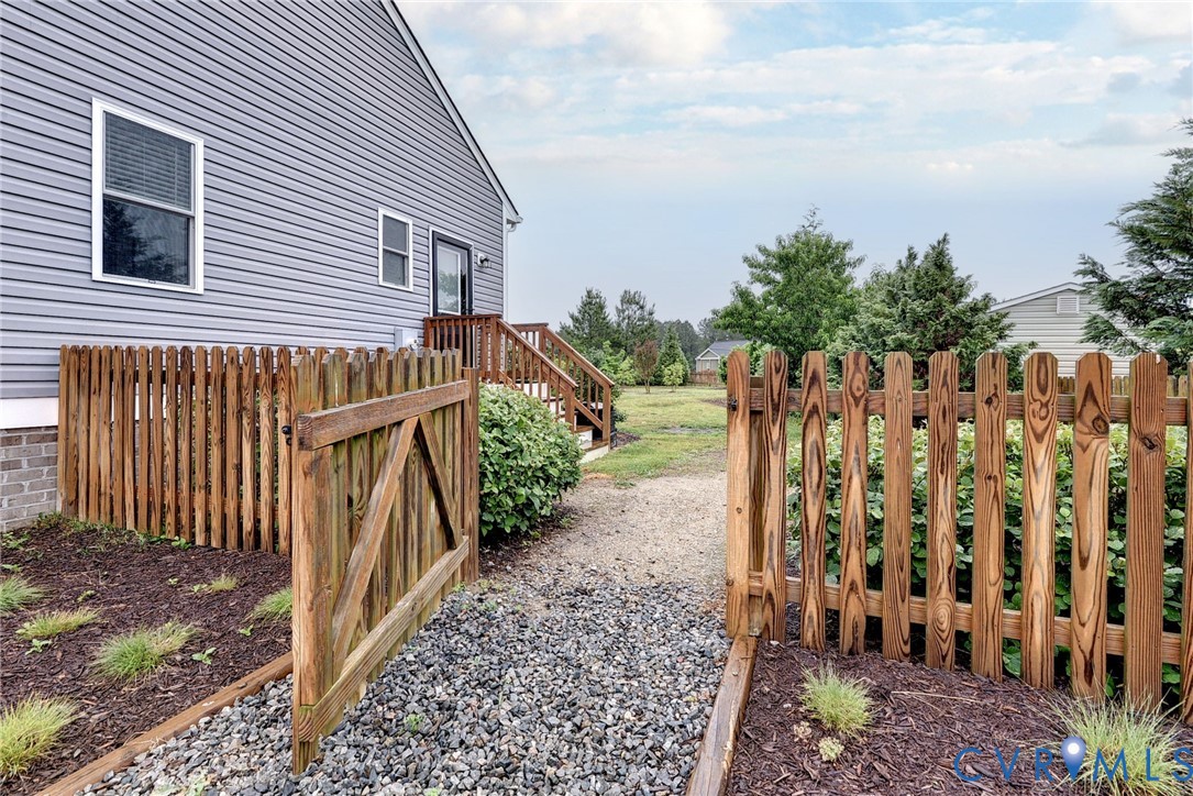 8904 Rock Cedar Road New Kent, VA 23124 - Photo 34 of 37 a view of a house with wooden fence