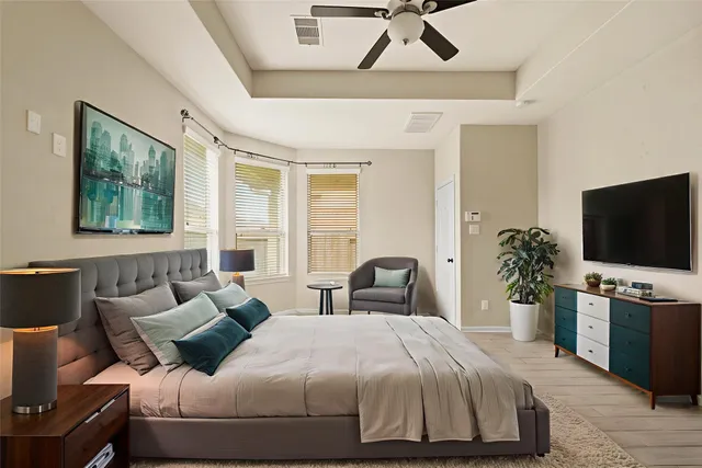 a bedroom with a bed and a flat screen tv