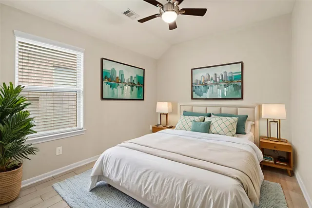 a bedroom with a large bed and a window