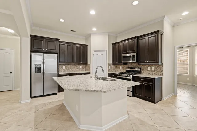 a kitchen with stainless steel appliances granite countertop a refrigerator oven a sink and dishwasher