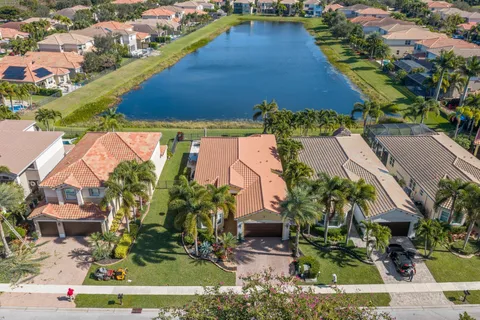 an aerial view of residential houses with outdoor space and swimming pool