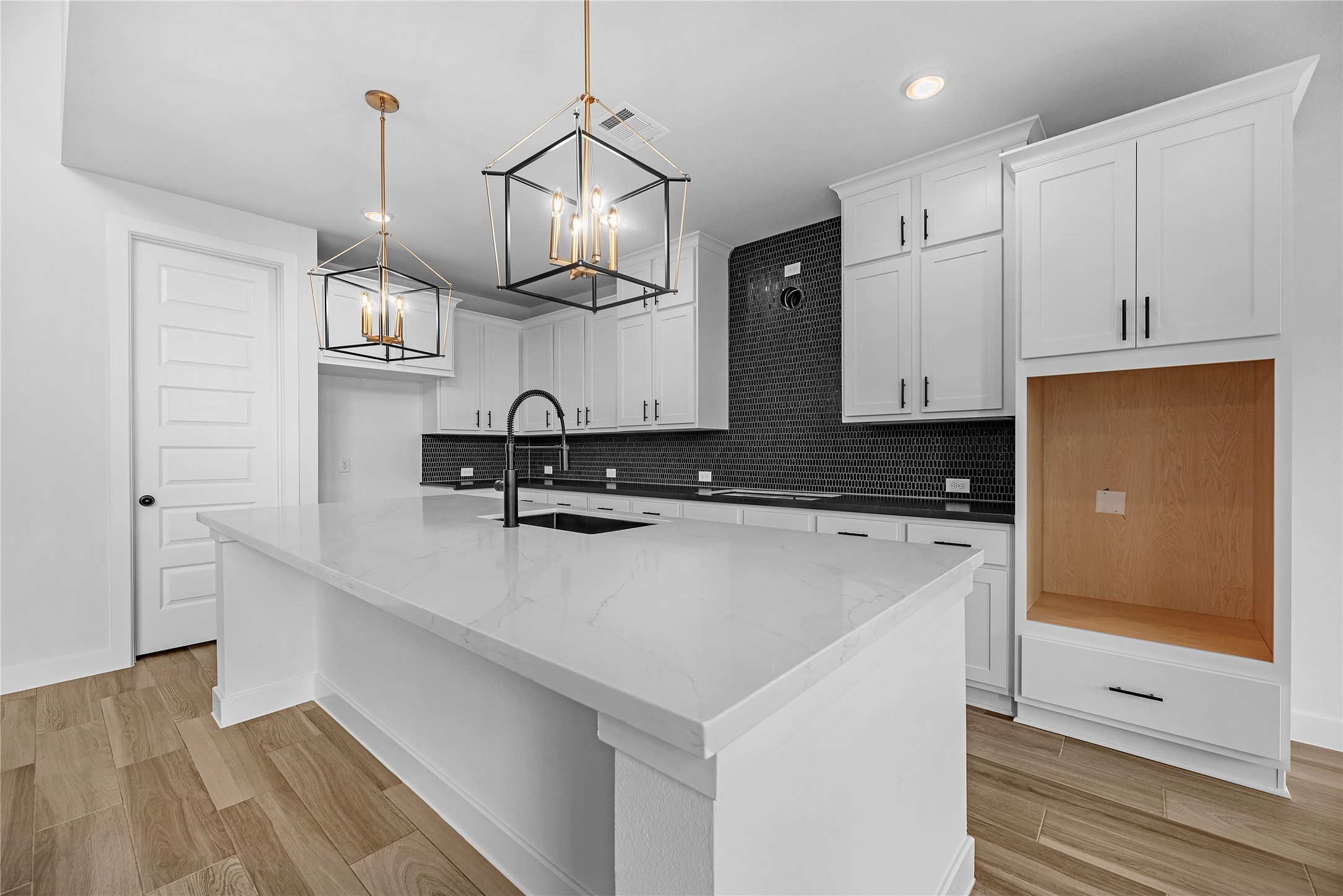 615 Roland Lane Rosenberg, TX 77471 - Photo 6 of 26 a kitchen with a sink a stove and cabinets
