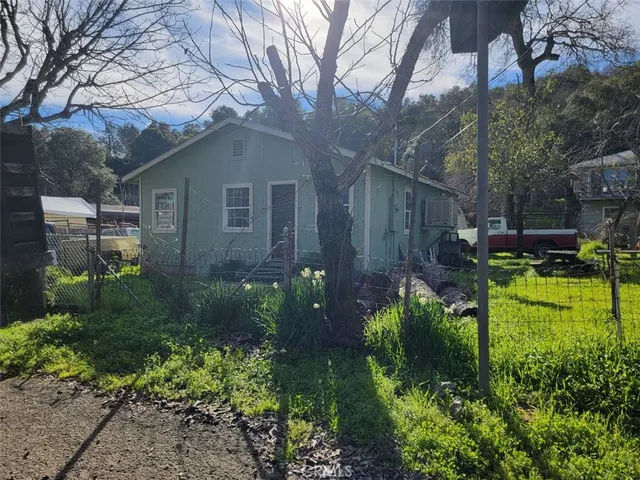 a backyard of a house with lots of green space and fountain