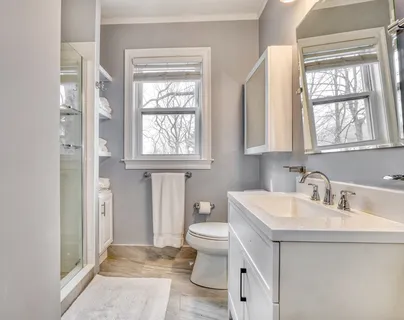 a bathroom with a toilet sink and a window