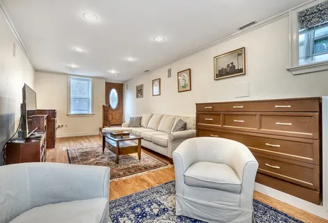 a living room with furniture and a dresser