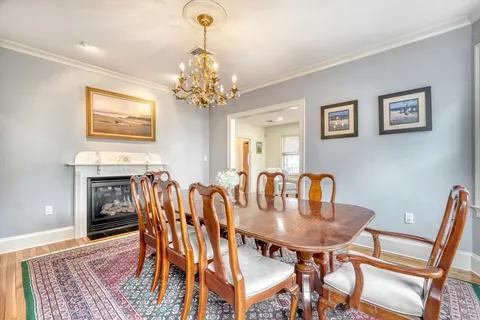 a view of a dining room with furniture and chandelier