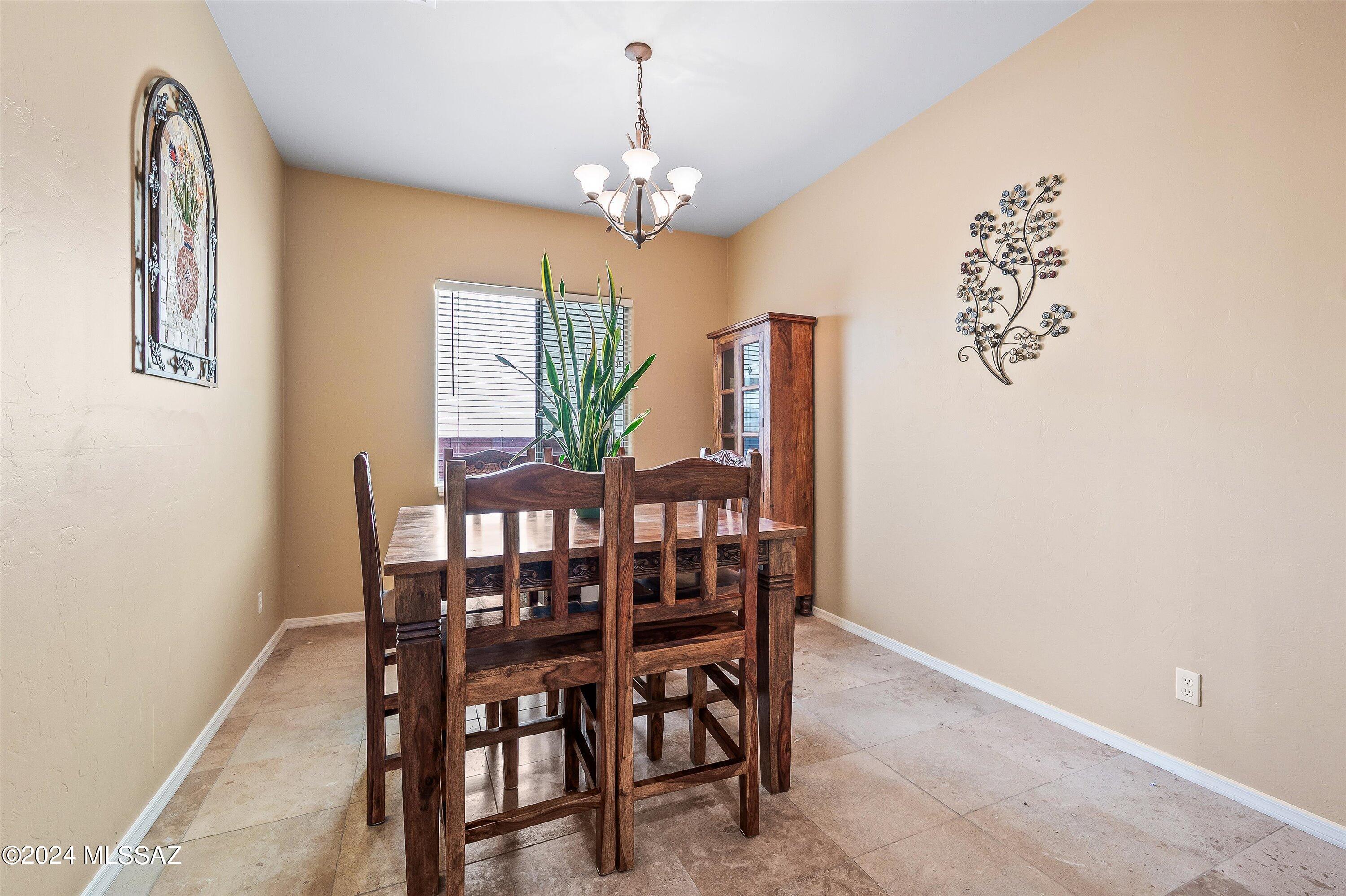 8579 North Shadow Wash Way Tucson, AZ 85743 - Photo 11 of 34 a view of a dining room with furniture and chandelier