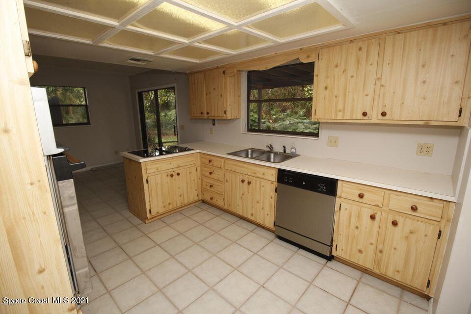 1495 Norbert Road Northeast Palm Bay, FL 32907 - Photo 2 of 10 a kitchen with stainless steel appliances a sink stove and cabinets