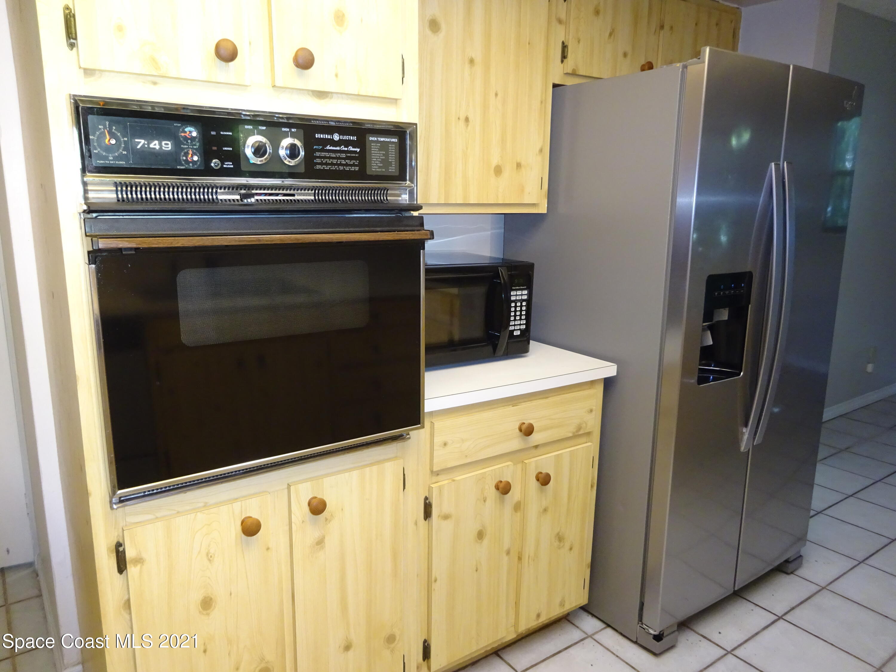 1495 Norbert Road Northeast Palm Bay, FL 32907 - Photo 3 of 10 a kitchen with stainless steel appliances a stove and a refrigerator