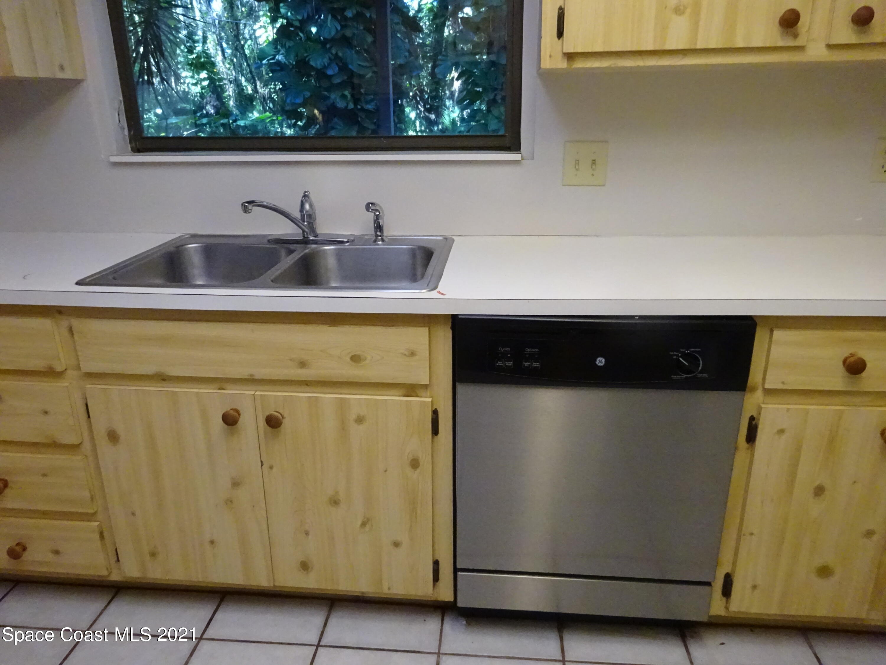 1495 Norbert Road Northeast Palm Bay, FL 32907 - Photo 4 of 10 a utility room with a wooden cabinets
