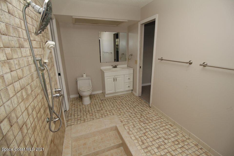 1495 Norbert Road Northeast Palm Bay, FL 32907 - Photo 7 of 10 a bathroom with a sink a toilet and shower