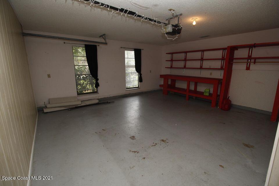 1495 Norbert Road Northeast Palm Bay, FL 32907 - Photo 10 of 10 en empty room with windows and ceiling fan