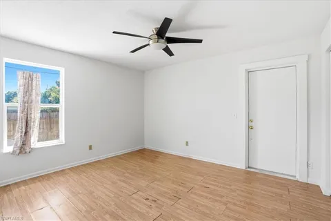 a view of a room with wooden floor and window