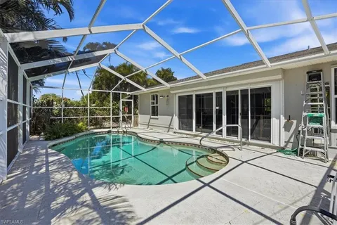 a view of a backyard with a patio and a tub