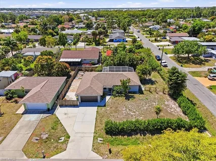 an aerial view of residential houses with outdoor space and street view