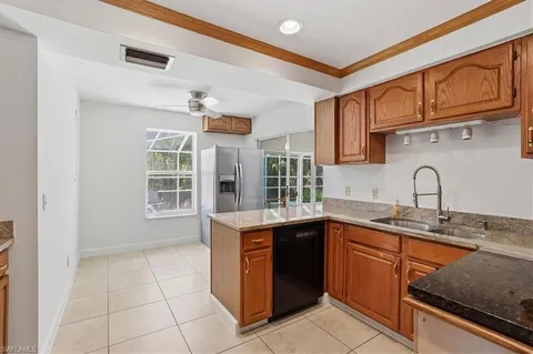 a kitchen that has a sink and a stove in it