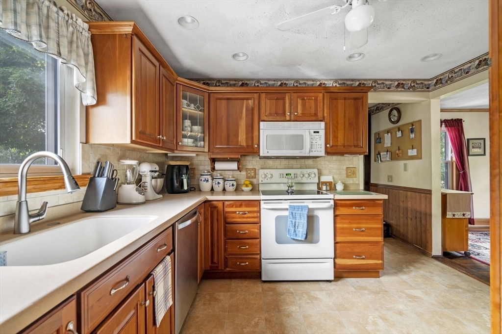 3 Trask Street Danvers, MA 01923 - Photo 15 of 29 a kitchen with stainless steel appliances granite countertop a sink window and cabinets