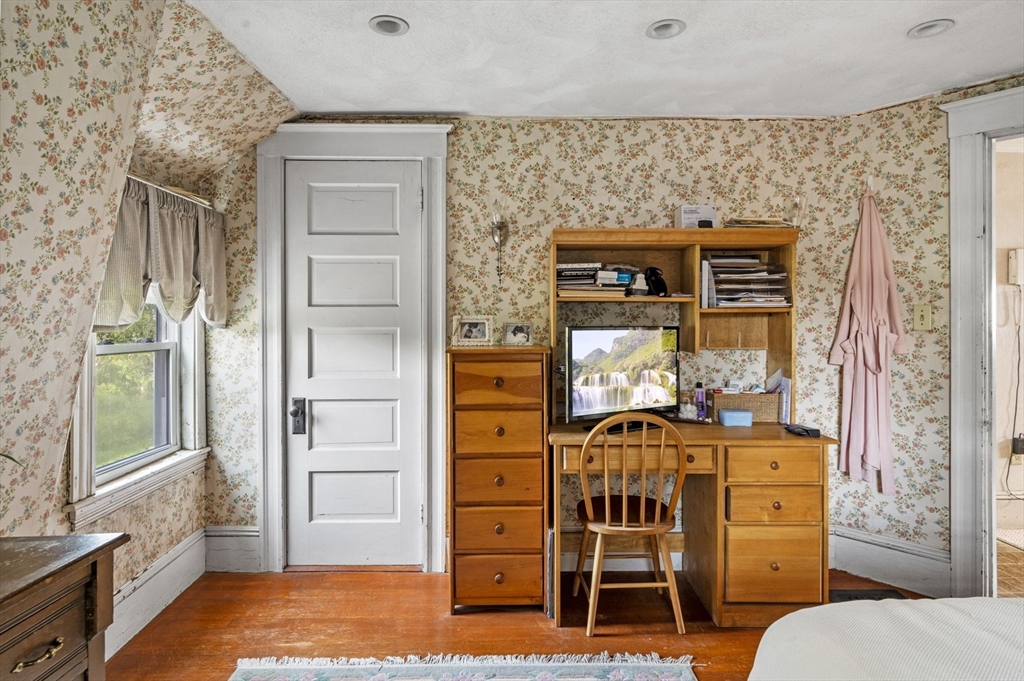 3 Trask Street Danvers, MA 01923 - Photo 23 of 29 a bedroom with a bed and wooden floor