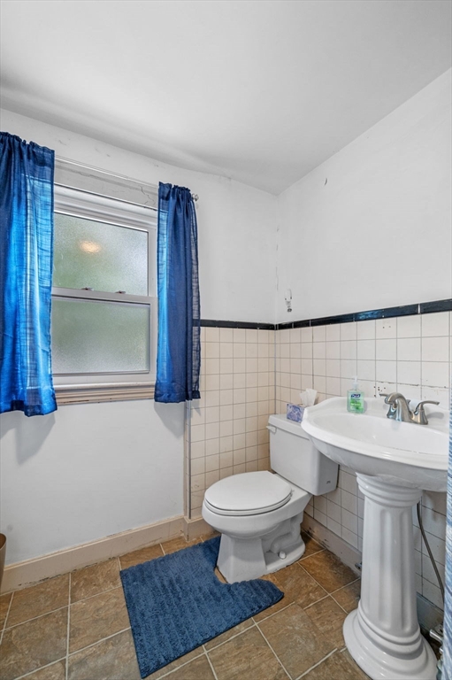 3 Trask Street Danvers, MA 01923 - Photo 25 of 29 a bathroom with a toilet a sink and mirror