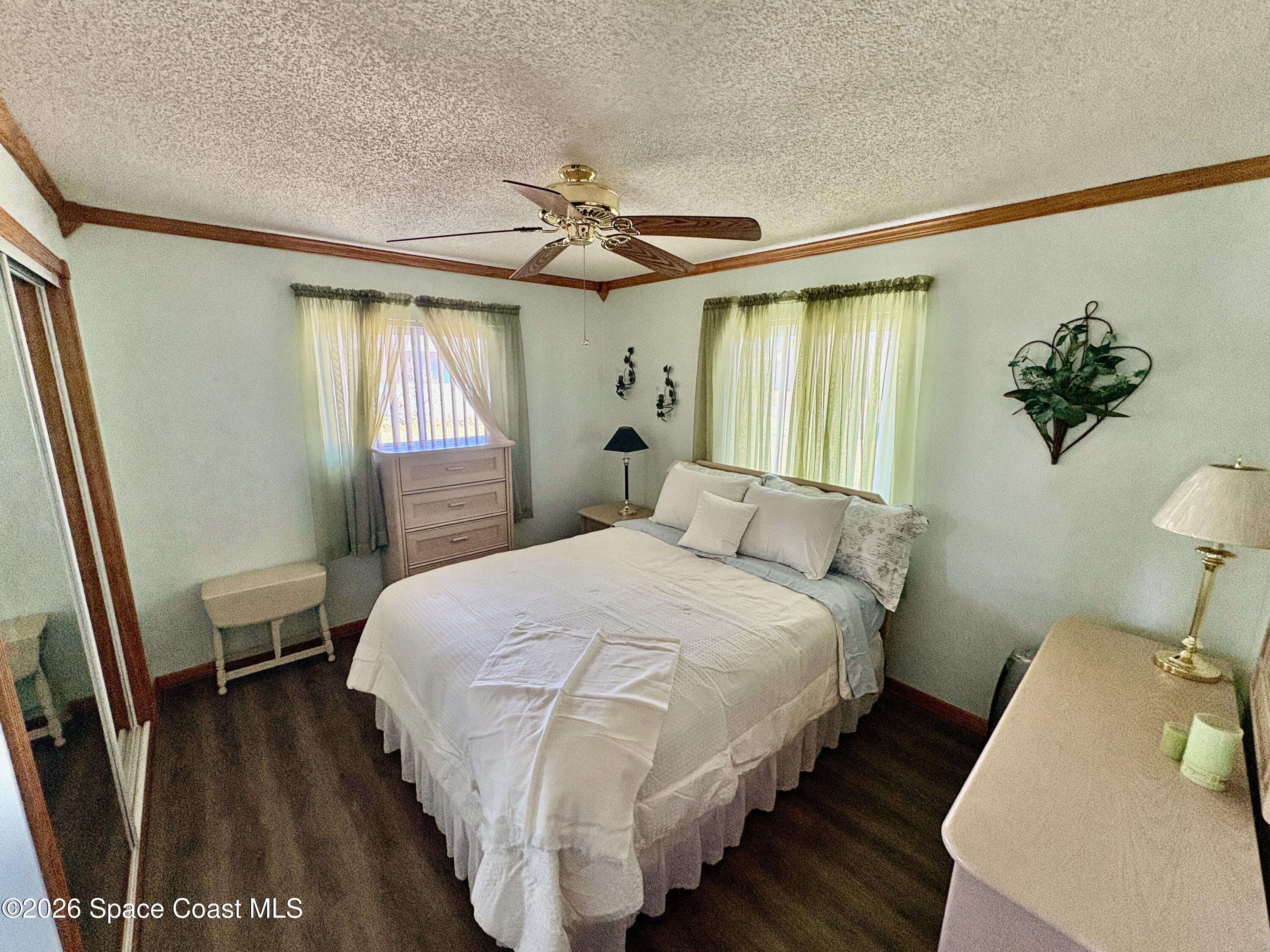 585 Crystal Mist Road Northwest Palm Bay, FL 32907 - Photo 12 of 21 a bedroom with a bed and a window