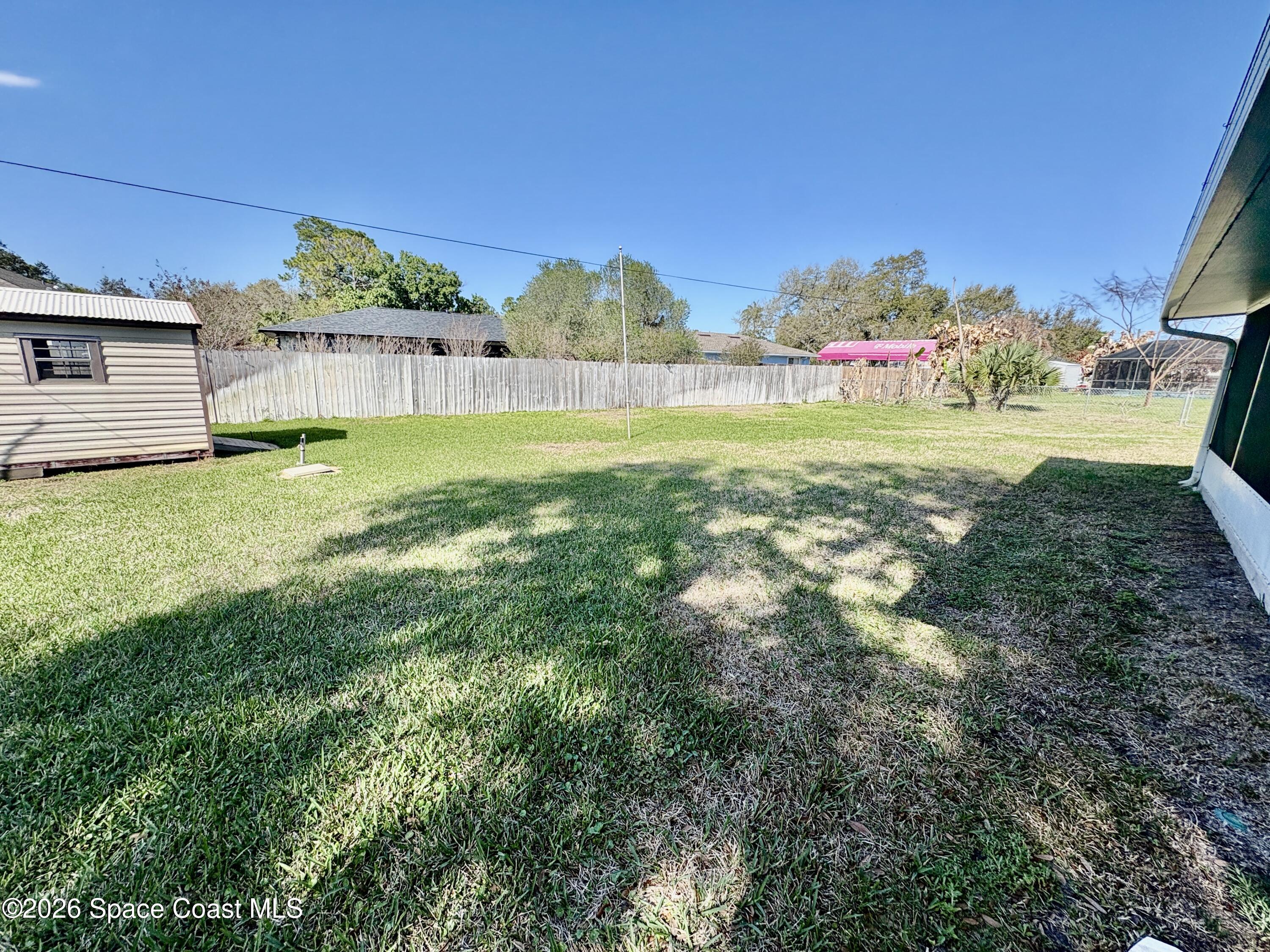 585 Crystal Mist Road Northwest Palm Bay, FL 32907 - Photo 19 of 21 a view of a house with a yard