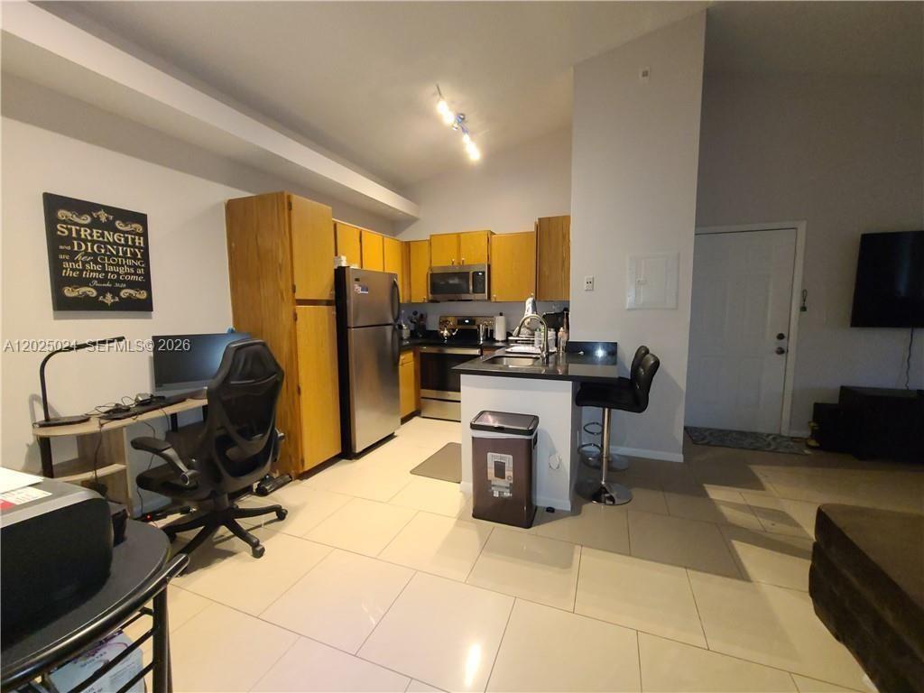 631 Lyons Road, Unit 12205 Coconut Creek, FL 33063 - Photo 2 of 14 a view of a workspace with furniture and a window
