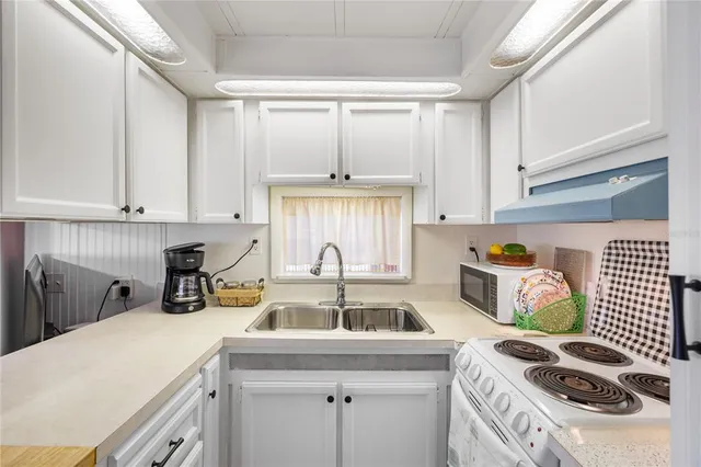 a kitchen that has a cabinets and a stove