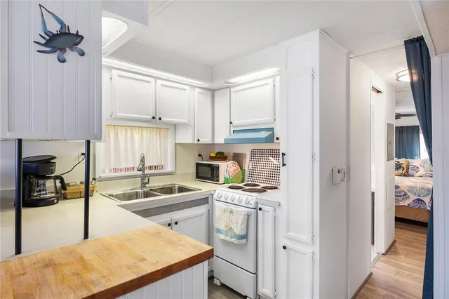 a view of a small space with wooden floor and a window