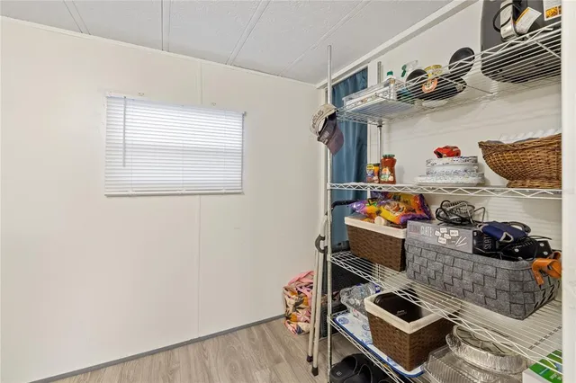 an entryway with wooden floor and cabinet