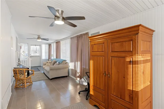 a view of a house with outdoor seating and a yard