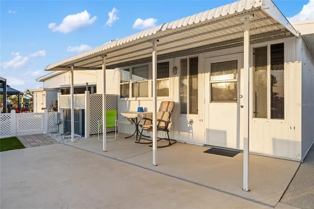 a view of a chair and tables in the patio